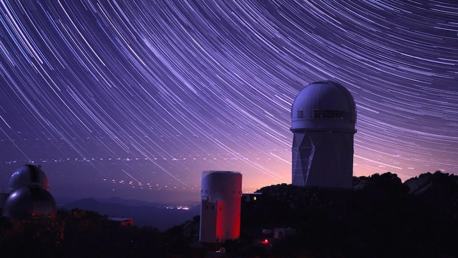 image of an observatory with a starry sky backdrop. 