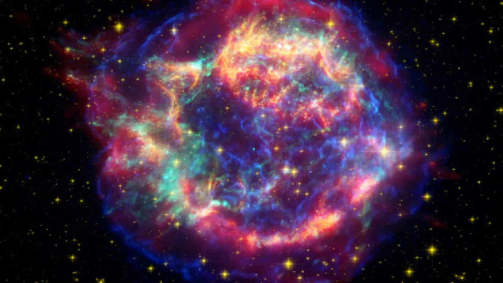 In 2007 NASA’s Spitzer space telescope found the infrared signature of silica (sand) in the supernova remnant Cassiopeia A. The light from this exploding star first reached Earth in the 1600s. The cyan dot just off center is all that remains of the star that exploded. NASA/JPL-Caltech/ O. Krause (Steward Observatory)