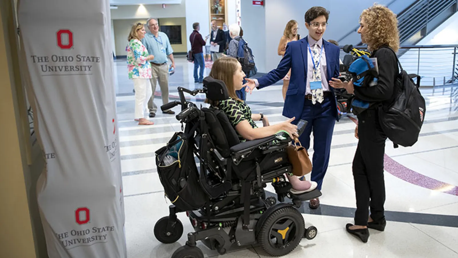 Anna (center) speaks with two presenters at the SciAccess conference she hosted.