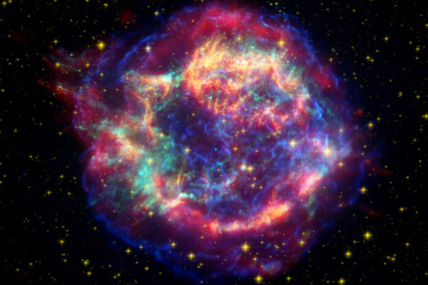 In 2007 NASA’s Spitzer space telescope found the infrared signature of silica (sand) in the supernova remnant Cassiopeia A. The light from this exploding star first reached Earth in the 1600s. The cyan dot just off center is all that remains of the star that exploded. NASA/JPL-Caltech/ O. Krause (Steward Observatory)